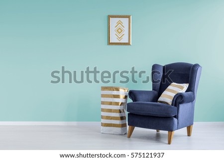 Room with mint wall and blue armchair