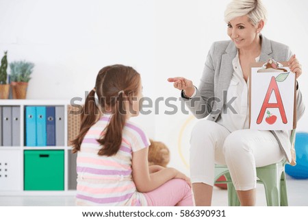Speech therapist and child with language disorder