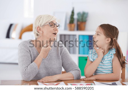 Stuttering girl and speech therapist doing exercises