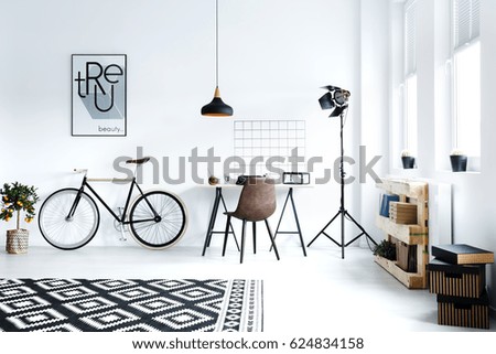 Black and white hipster room with bicycle, desk, pattern carpet