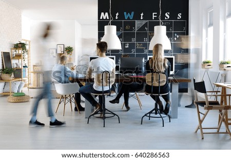 People working in modern, creative work environment