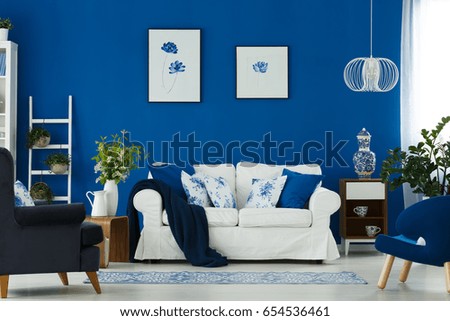 White sofa and blue armchairs in cozy living room