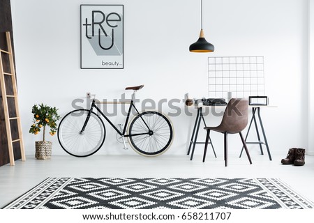 Modern black and white room interior with desk and bike