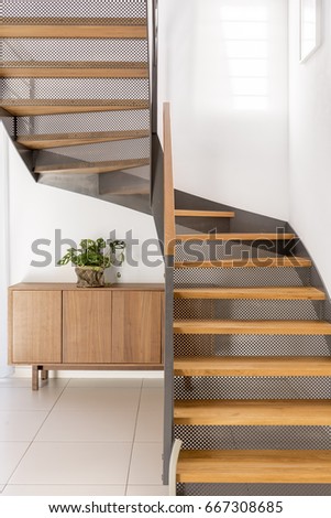 Industrial metal and wooden half-landing stairs in simple family home