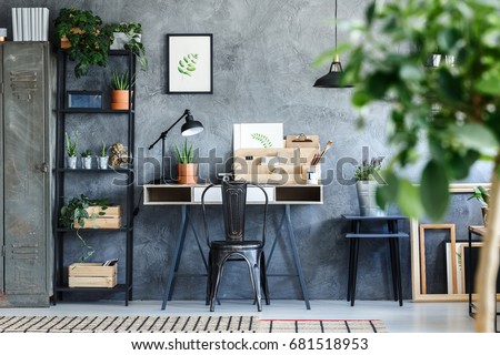 Plants and botanical illustrations in artistic office room interior