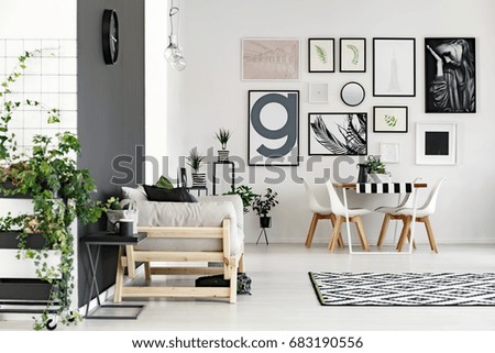 Stylish living room with sofa connected with small dining hall
