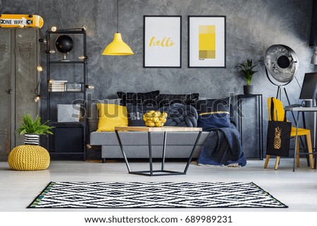 Optimistic teenager\'s room with gray wall, furniture and yellow accents