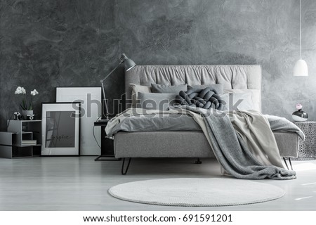 Loft style bedroom with gray design, concrete wall and modern furniture