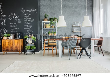 Chalkboard accents and mismatched chairs in eclectic dining room