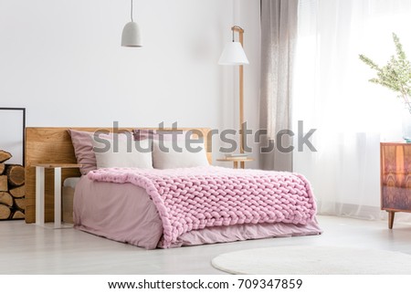 Scandinavian classic bedroom with king-size bed, commode and big lamp