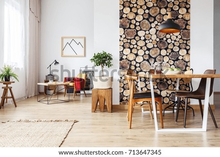 Dining table and rustic brown chairs in contemporary spacious flat with wooden accents