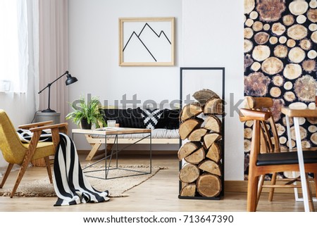 Cozy winter interior design for minimalist with wooden accessories, warm colors and fire logs