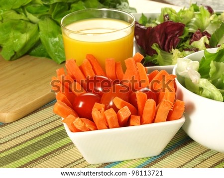Carrot sticks with lettuce and orange juice healthy diet.
