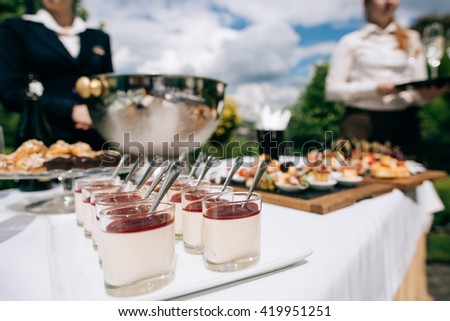 catering services  in restaurant outdoor on wedding ceremony in the park.\
Food and glass of champagne