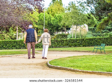 Elderly people walking in the park.