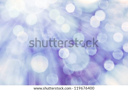 Blue spotted background with rays of light