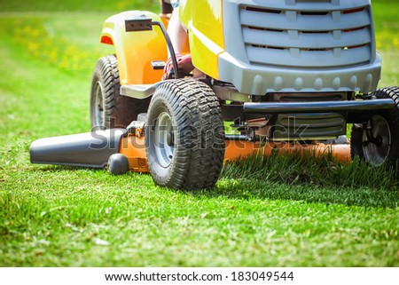 Closeup of mower cutting the grass