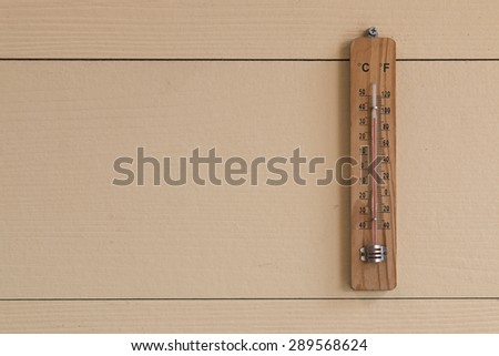 thermometer on wood background