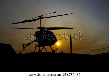 toy helicopter at sunset on the roof