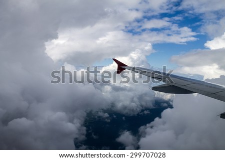 view of storm clouds from airplane window