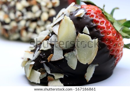 Strawberry dipped in chocolate covered in almond nuts