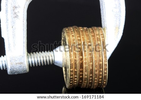 Tighten the Budget US Currency gold coins in a clamp vise