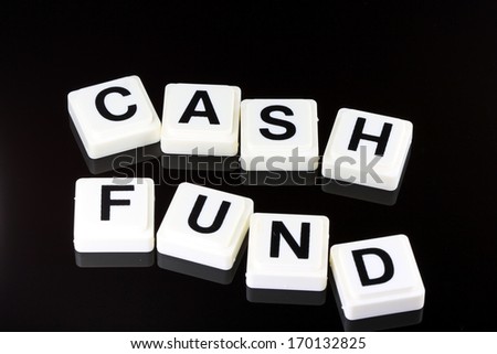 The words cash fund spelled out with white tiles on black background - A term used for business in finance and stock market trading