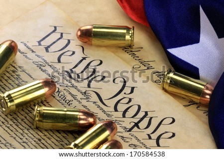 Ammunition and American flag on US Constitution - History of the Second Amendment