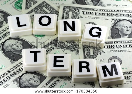 The words long term on US currency background - A term used in futures and options trading