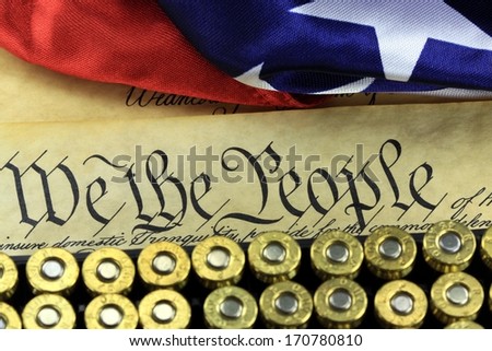 US Constitution Bill of Rights with 45 caliber bullets and American flag