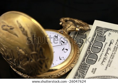 time and money concept - pocket watch and one hundred dollar bills