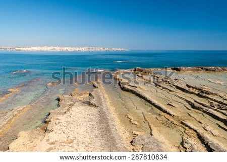 The coastline in the marine protected area of Plemmirio, in Sicily. The city in the background is Syracuse.
