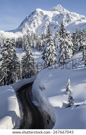 Mt Baker Road Gap With Two Jumps Built and Mt Shuksan Towering in the Blue Sky Background