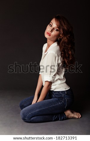 Lovely woman in white blouse and blue jeans