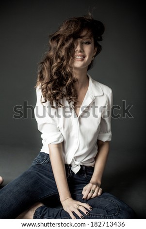 Lovely woman in white blouse and blue jeans