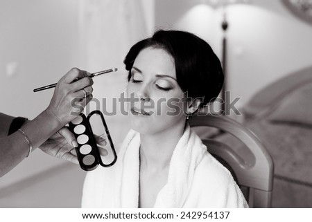 Beautiful bride wedding makeup and hair-style. Stylist makes makeup bride on wed-ding day. portrait of young bride at wedding day