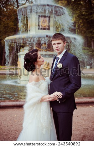 Bride and groom against fountain