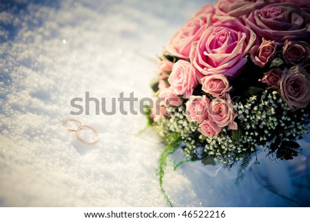 stock photo wedding bouquet and the ring in the snow