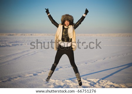 Woman jumps over the lake in winter