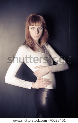 Fashion woman standing against a background of writing boards