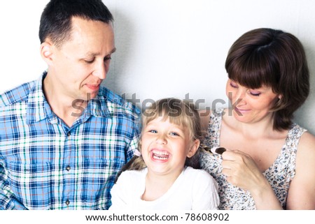 Happy family with child posing on white background