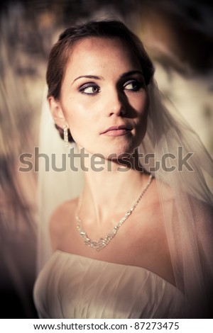 stock photo Portrait of a woman in a wedding dress among the branches