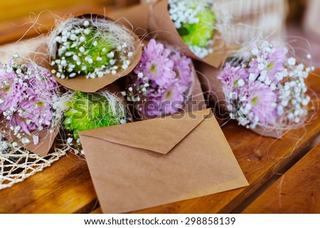 Envelope and flower bouquet on the wooden table