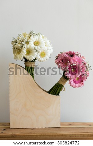 Pink and white gerbera bouquets in a wooden box