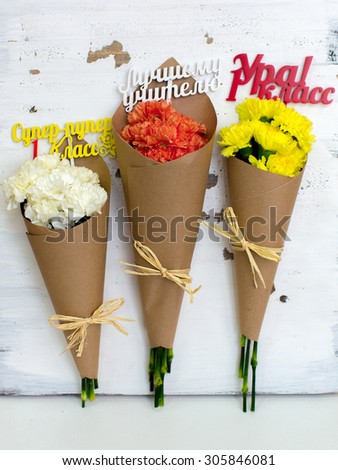 Three colored bouquet of carnations in paper cornet. 