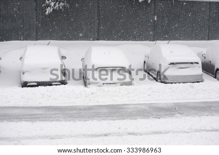 car covered with snow after blizzard in parking area