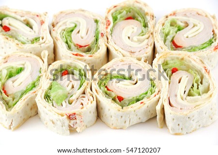 tortilla deli wrap rolls with ham vegetable isolated on white background