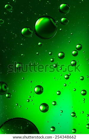 Oil and water vivid green abstract, giving the impression of rising bubbles
