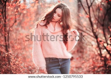 Young woman in Living Coral forest. Color of the year 2019. Main trend natural and authentic concept.