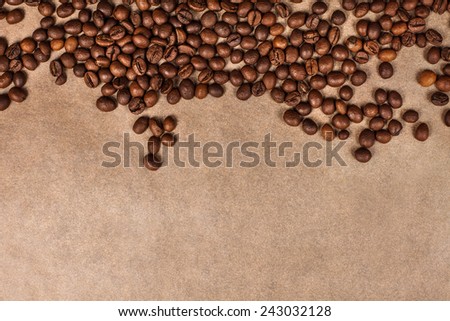 background of coffee beans with space for writing lying on brown parchment